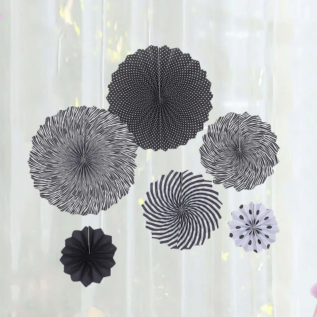 Black and white decorative paper fans in various designs.