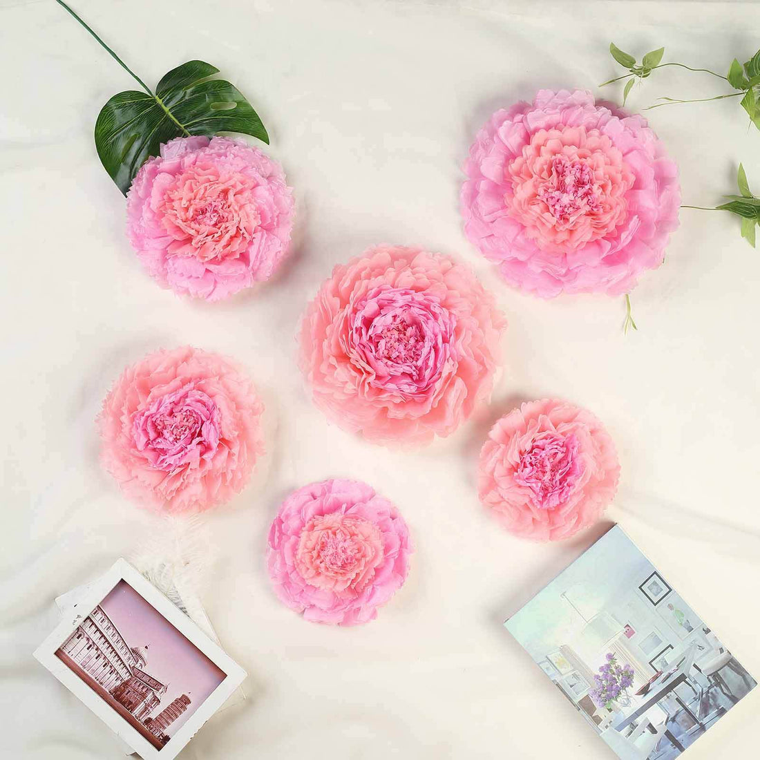 Pink decorative flowers arranged artistically on a light background.