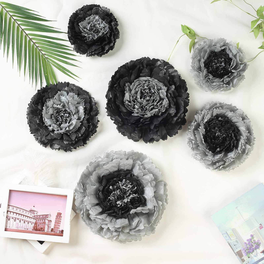 Black and gray decorative paper flowers arranged artistically.
