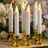 Set of six LED candle holders with gold bases and flickering flame-like tops.
