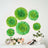 Green paper flower wall decor in varying sizes for home decoration.