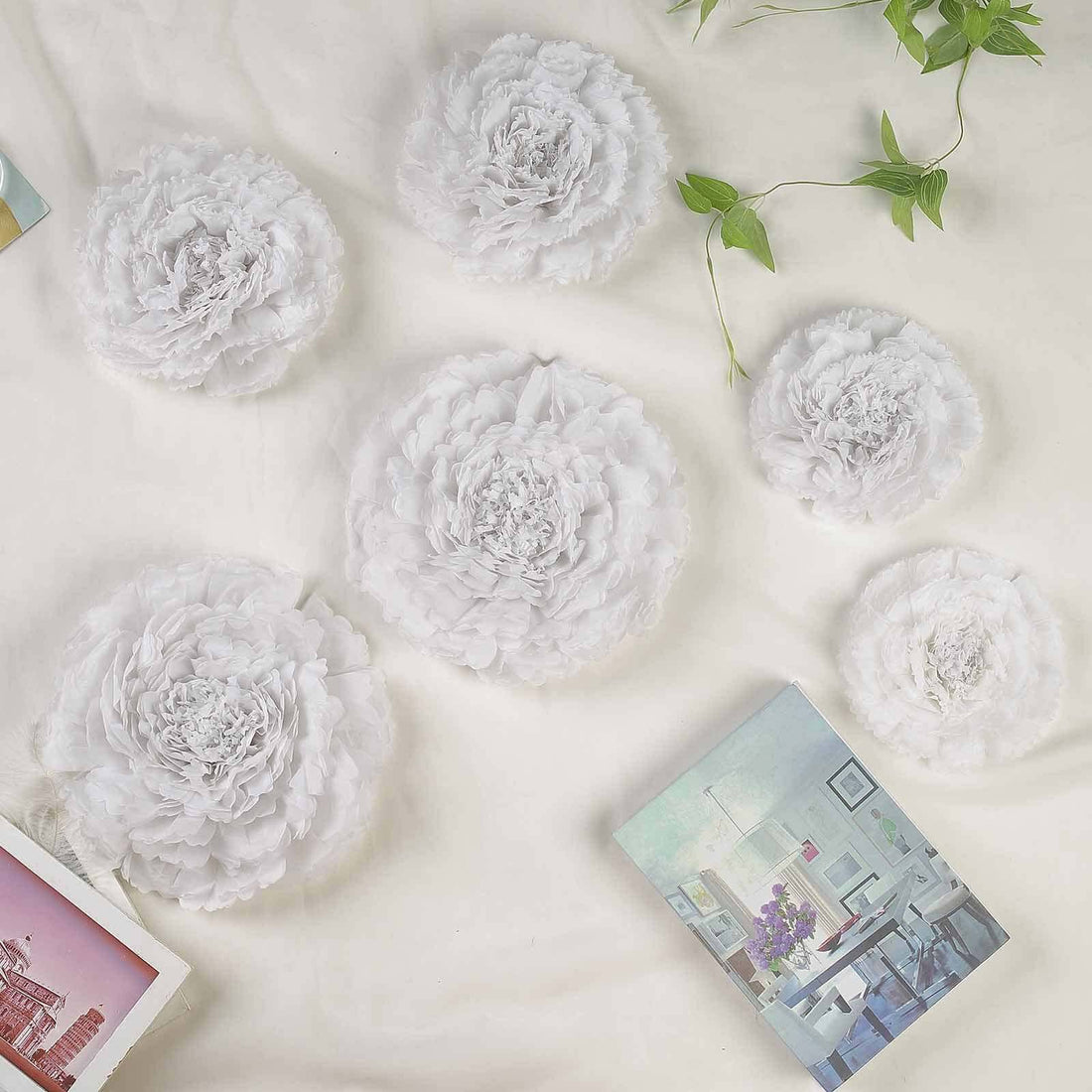 White decorative peonies arranged on a light background with a book.