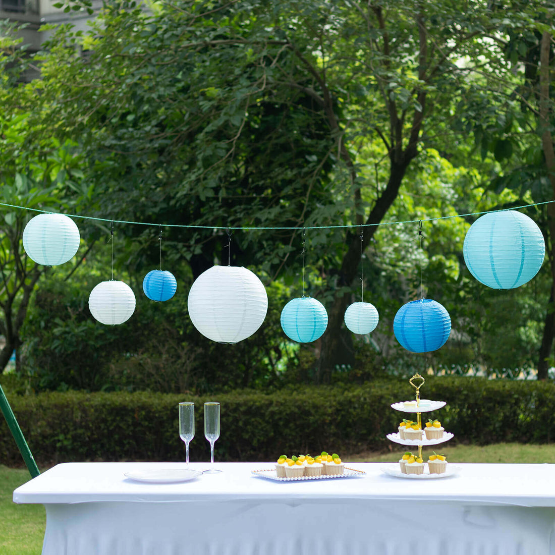 Colorful paper lanterns hanging outdoors at a festive event.