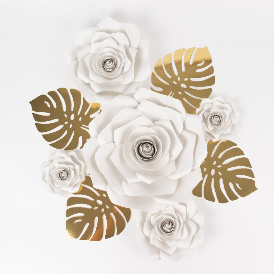 White and gold paper flowers arrangement on a white background