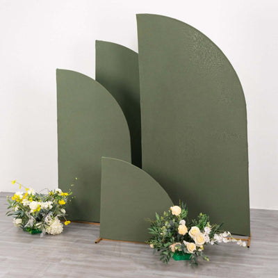 Curved green backdrop panels with floral arrangements in front