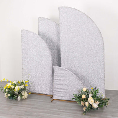 Glittery decorative backdrops with floral arrangements on the floor.