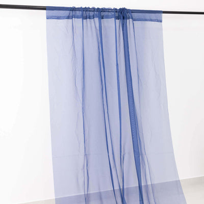 Sheer blue curtain hanging from a rod against a white background