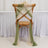 Chair decorated with flowing green and beige fabric drapes.