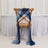 Wooden chair with blue and navy sheer fabric draped over it.