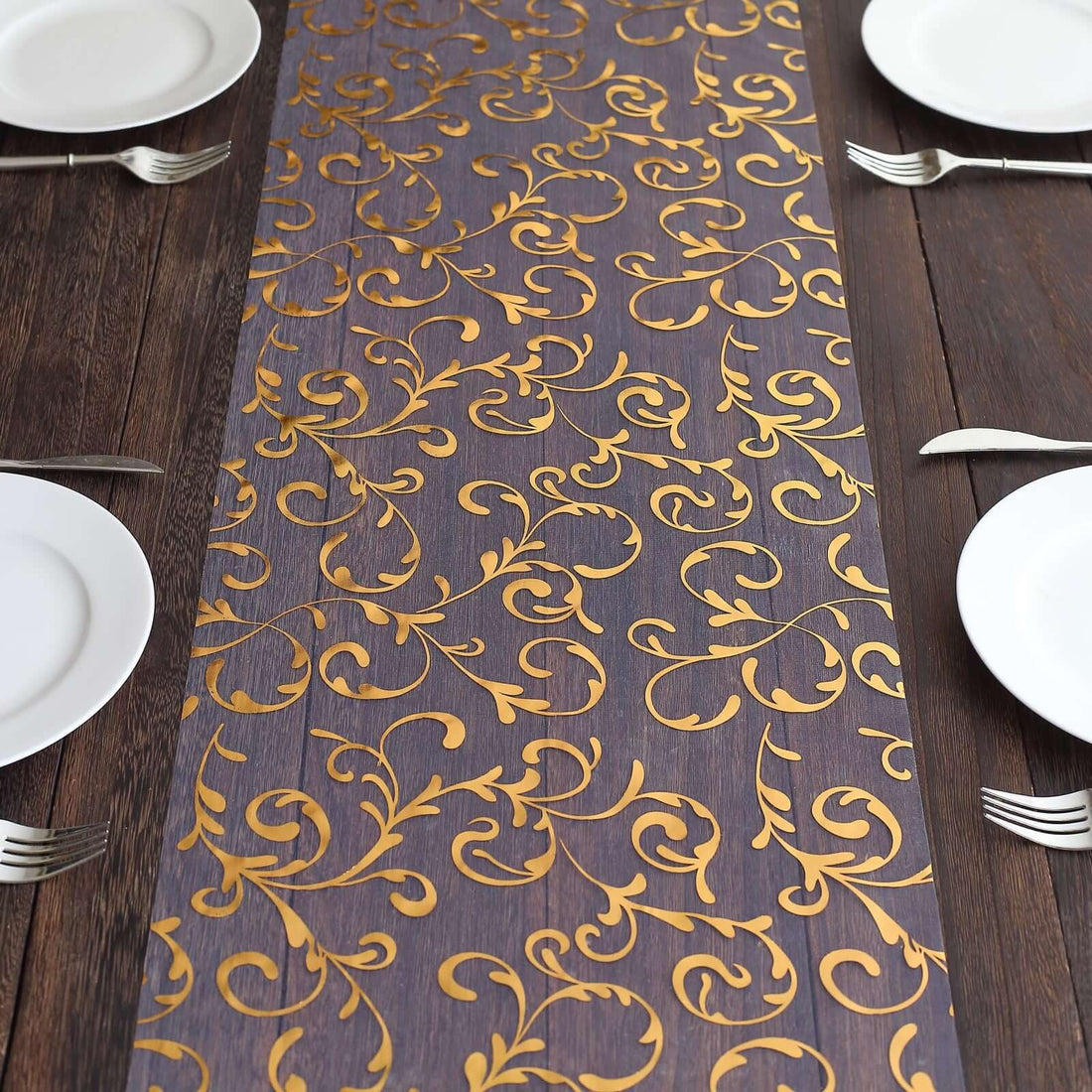 Elegant gold floral table runner on a wooden table setting.