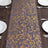 Elegant gold floral table runner on a wooden table setting.