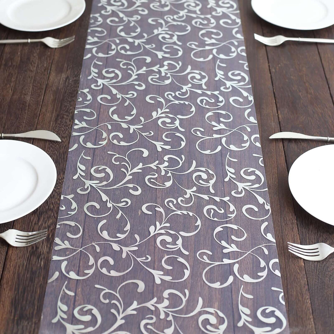 Elegant floral table runner on a rustic wooden dining table.