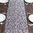 Elegant floral table runner on a rustic wooden dining table.