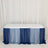Table with blue ombre draped tablecloth on a plain backdrop