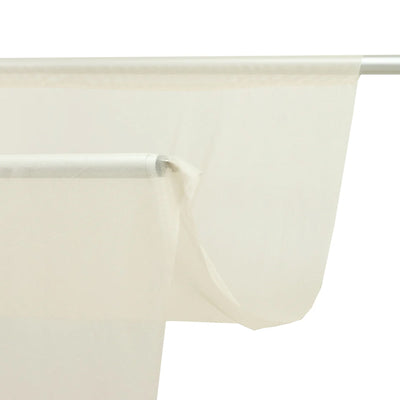 Sheer white curtain hanging on metal rod with tear detail