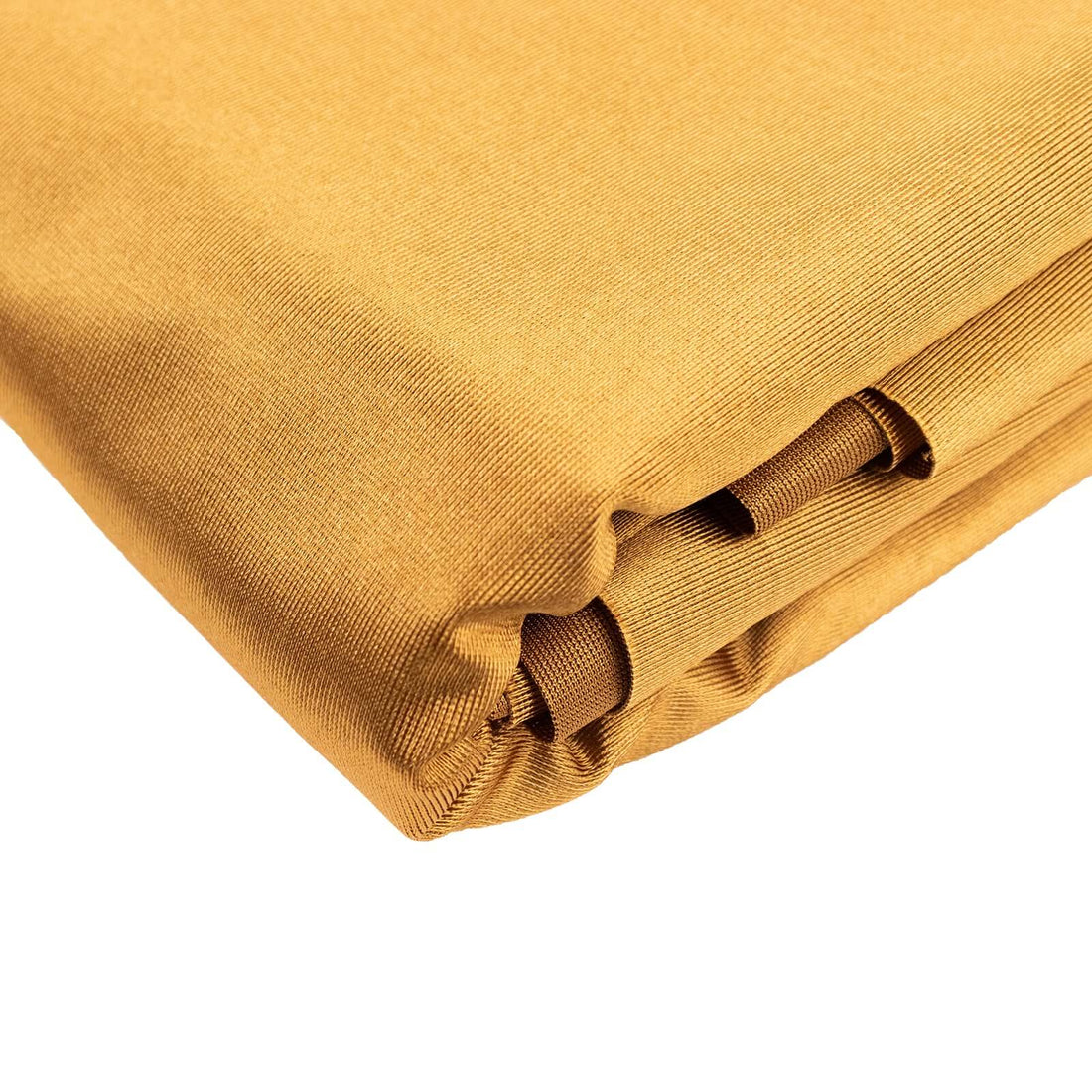 Golden fabric roll with smooth texture and folded edges