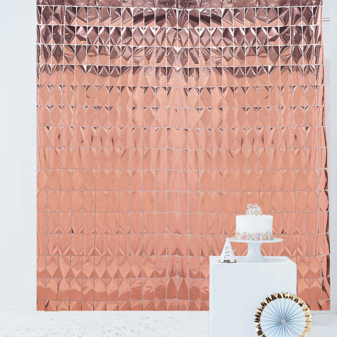 Rose gold geometric party backdrop with cake display