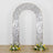 Decorative silver arch with floral arrangements at the base.