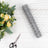 Wire mesh roll with scissors and floral arrangement on a wooden background.