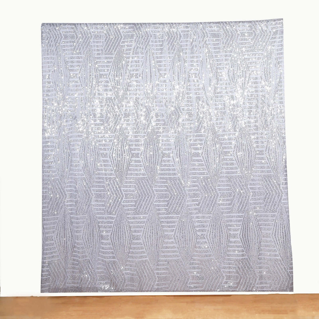 Silver sequin backdrop with a geometric pattern for events and photography.
