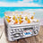 Inflatable cooler with bottles on a beach background.