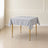 silver wrinkle-resistant square tablecloth on a wooden table