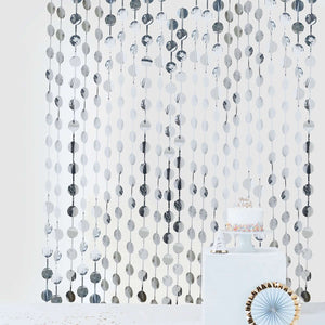 Decorative backdrop with hanging circular accents for events or celebrations.