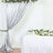 Elegant wedding decoration with draped silver fabric and floral arrangements.
