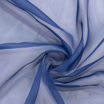 Lightweight sheer blue fabric draping in an elegant swirl. #whtbkgd