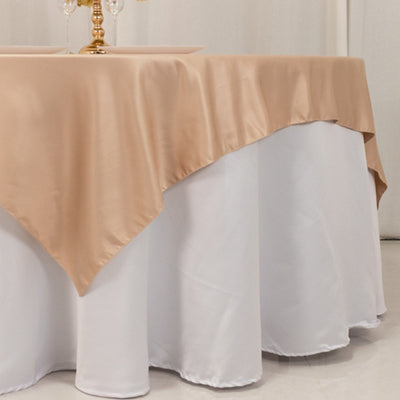 Elegant beige tablecloth draped over a white round table.