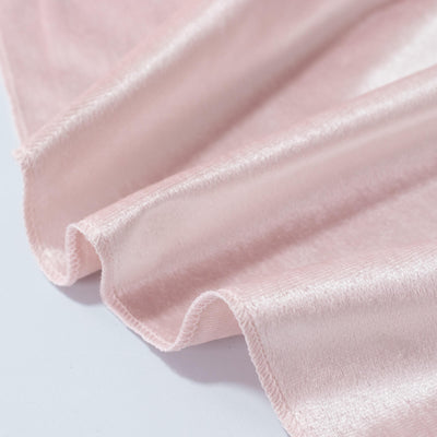 Soft blush pink satin fabric with elegant rippled folds