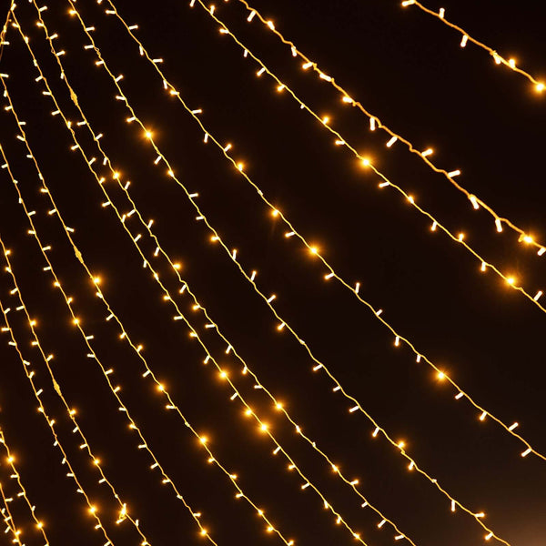 Warm white string lights glowing against a dark backdrop.
