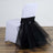 Elegant black tulle chair cover with a sleek white base.