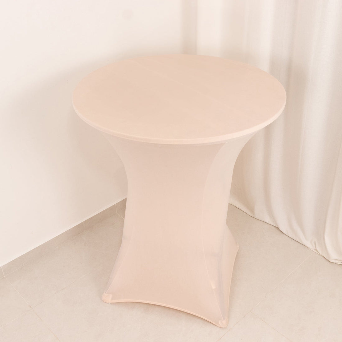 Round table with a sleek, modern design in a soft beige color.