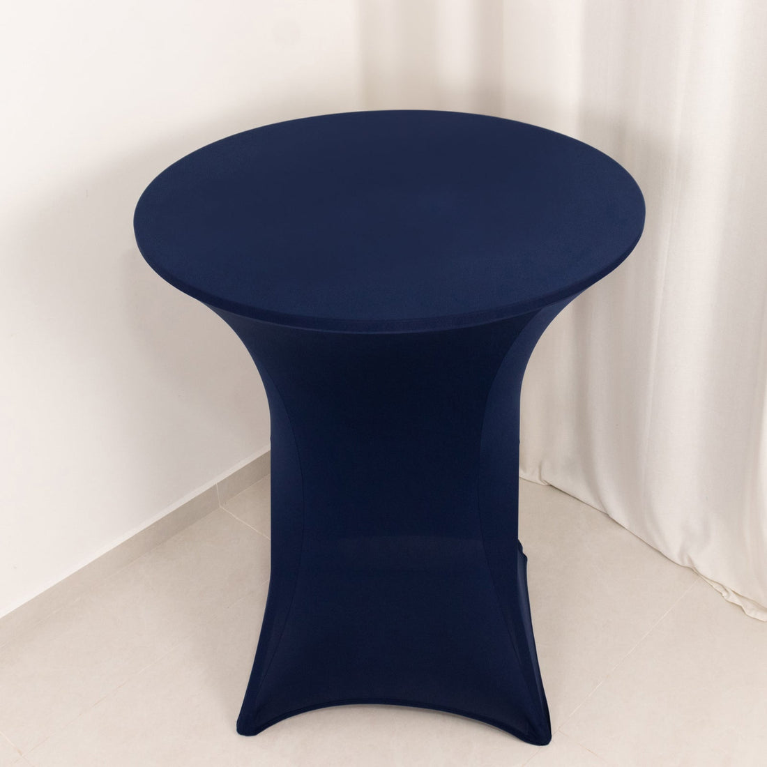 Navy blue stretch table cover on a round table