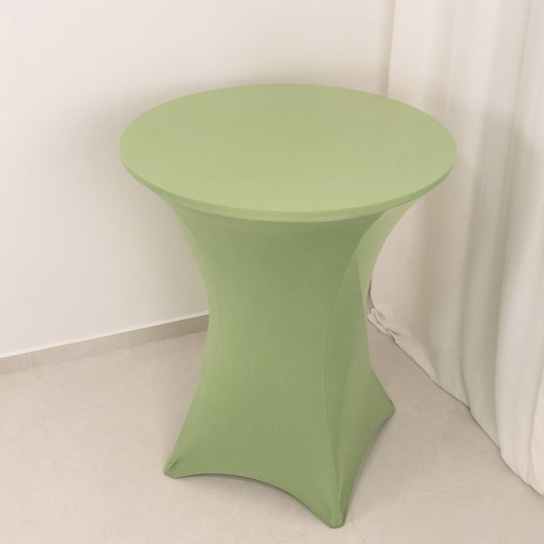 Green round table cover on a sleek, modern table.