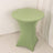Green round table cover on a sleek, modern table.