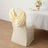Elegant cream chair cover with draped design for special events.