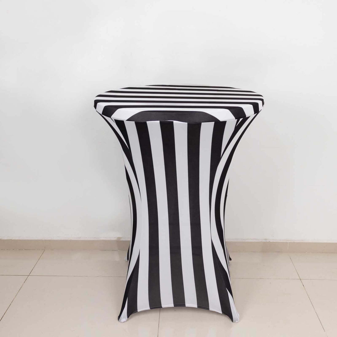 Striped table cover with black and white design on a plain backdrop