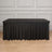 Black tablecloth draping over a rectangular table in a staged setting.