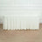 White table cover draped over a rectangular table in a studio setting.