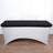 Black table cover on a white table with curved design.