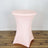 Pink stretch table cover on a round table in a studio setting.