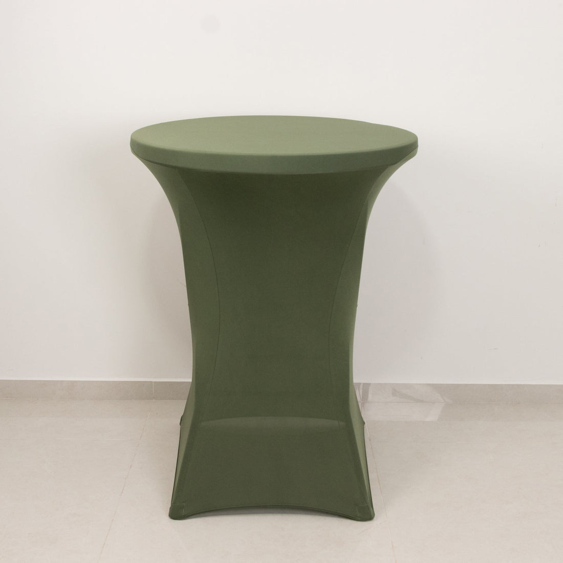Green round table with a sleek design against a plain background.