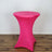 Pink stretch table cover on a round table against a plain backdrop.