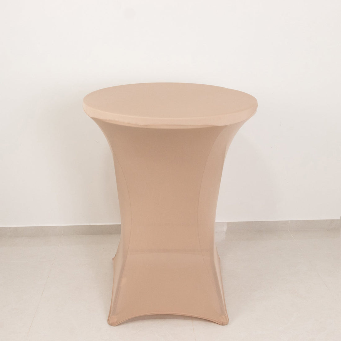 Round beige table on a plain background