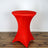 Red stretch table cover on a round table against a plain backdrop.