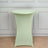 Green stretch table cover on a round table in a studio setting.