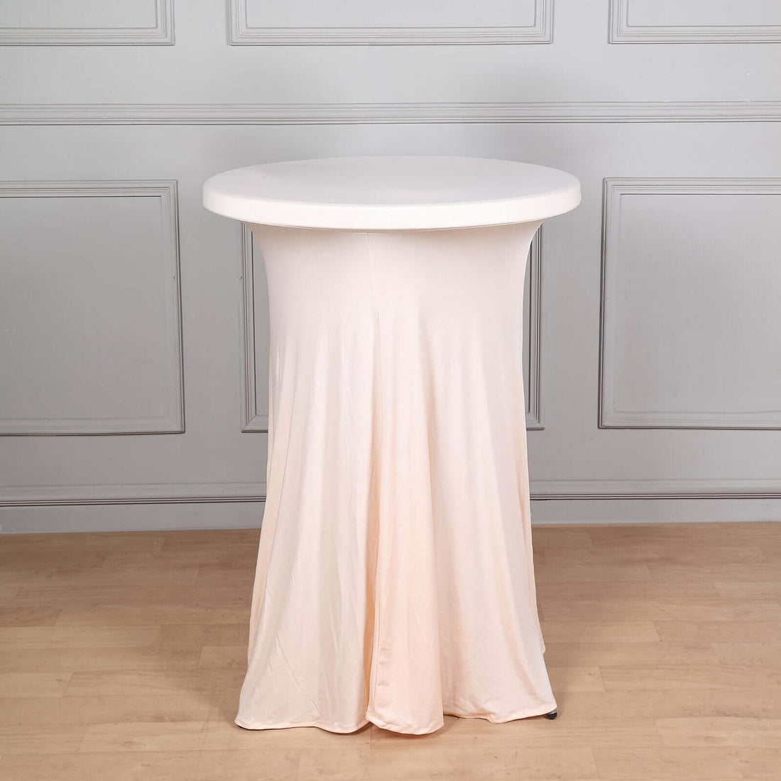 Round table with a soft, draped cover in a minimalist setting.