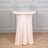 Round table with a soft, draped cover in a minimalist setting.